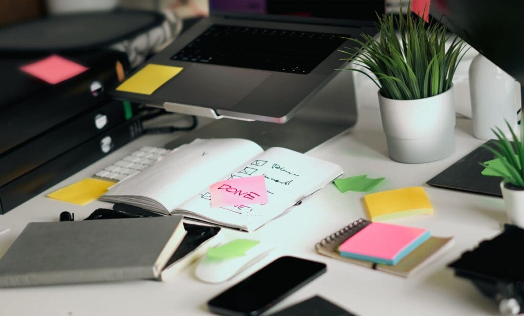 Cluttered desk showing signs you're ready to hire a VA